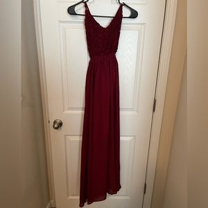 Long red dress with lace bodice.